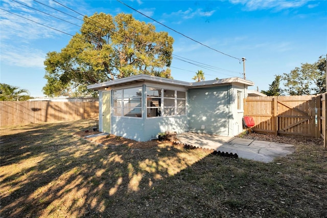 back of house with a lawn