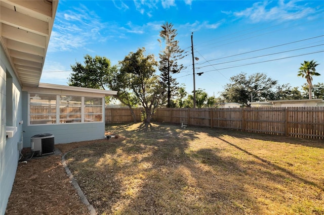 view of yard featuring a sunroom and cooling unit