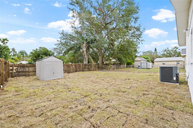 view of yard featuring a shed and central AC