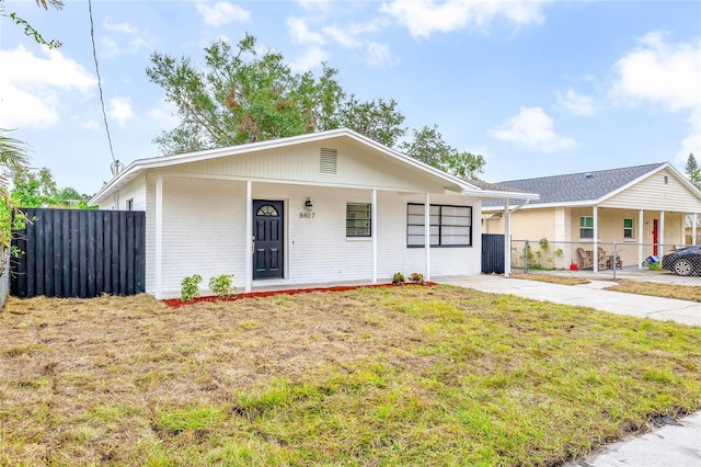 ranch-style house with a front lawn and a porch