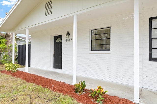 view of exterior entry featuring a porch