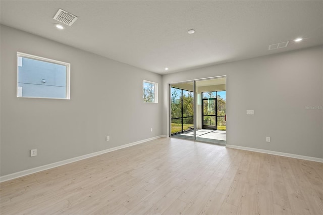 unfurnished room with light hardwood / wood-style flooring