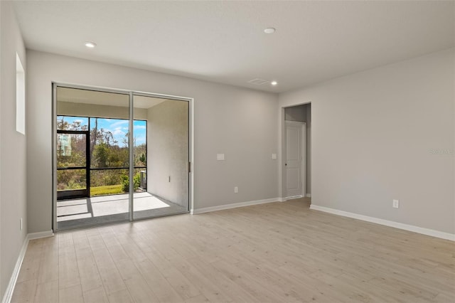 spare room featuring light hardwood / wood-style floors