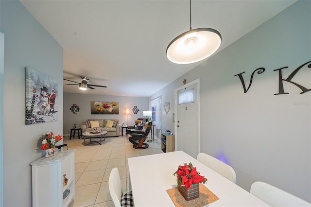 tiled dining space featuring ceiling fan