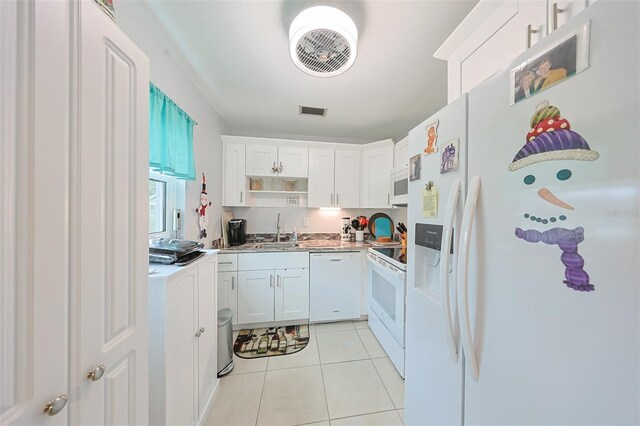 kitchen featuring sink, white cabinets, white appliances, and light tile patterned floors