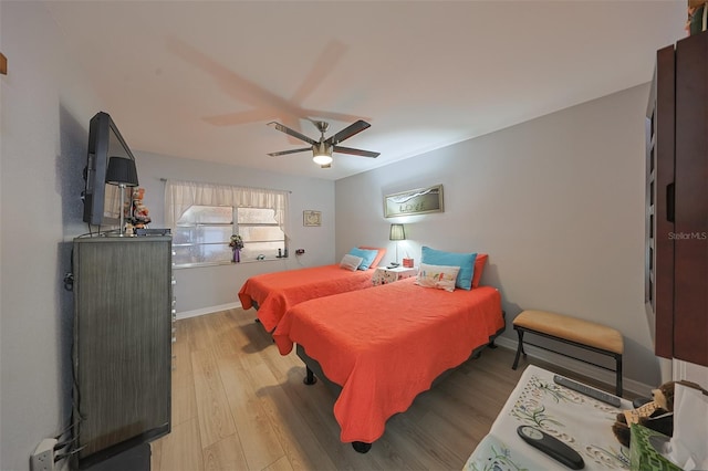 bedroom featuring ceiling fan and light hardwood / wood-style flooring