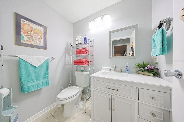 bathroom with tile patterned flooring, vanity, and toilet