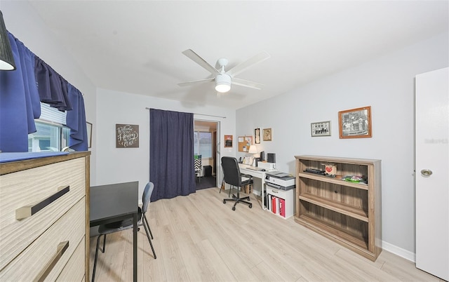 home office with ceiling fan and light hardwood / wood-style floors