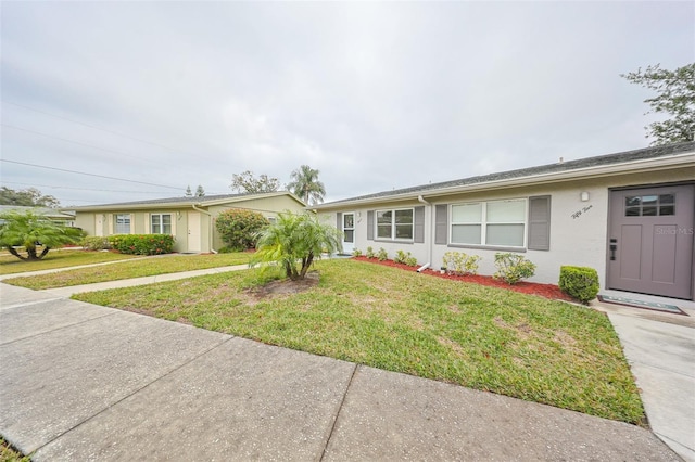 ranch-style home with a front lawn