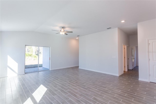 empty room featuring ceiling fan, light hardwood / wood-style floors, and vaulted ceiling