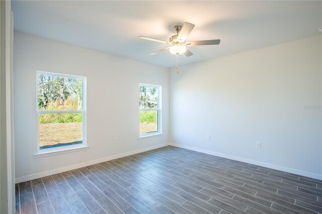 20118 Quesada Ave, Port Charlotte, FL 33952 - empty room featuring plenty of natural light, baseboards, a ceiling fan, and dark wood-style flooring