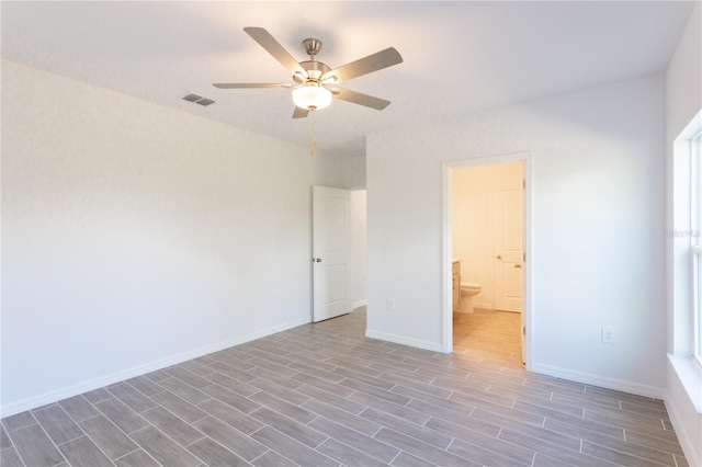 empty room featuring ceiling fan and dark wood-type flooring