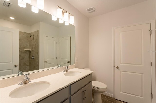 20118 Quesada Ave, Port Charlotte, FL 33952 - bathroom featuring double vanity, toilet, and tiled shower