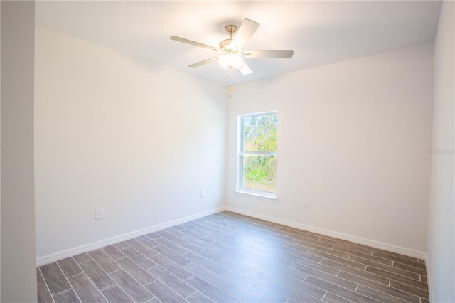 empty room featuring ceiling fan and dark hardwood / wood-style flooring