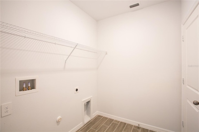 laundry area featuring hookup for an electric dryer, hookup for a washing machine, and hardwood / wood-style flooring