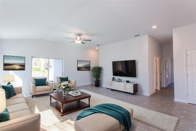 living room with light hardwood / wood-style flooring, ceiling fan, and lofted ceiling