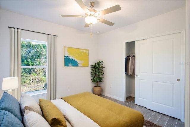 bedroom with ceiling fan, a closet, and hardwood / wood-style flooring