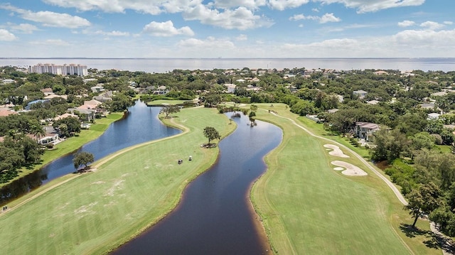 birds eye view of property with a water view and view of golf course