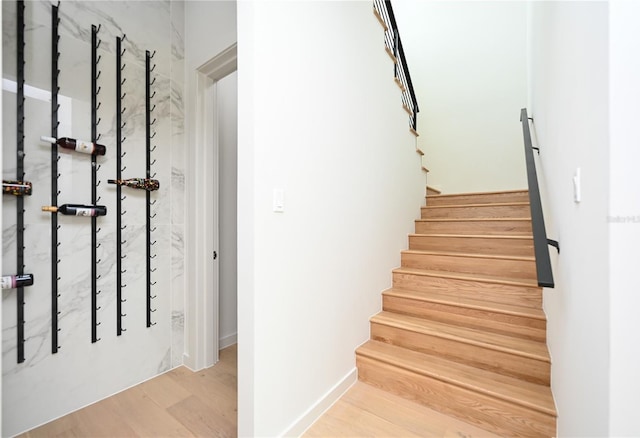 stairs featuring hardwood / wood-style flooring