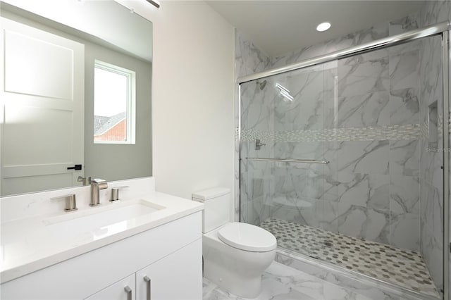 bathroom with vanity, toilet, and a shower with shower door