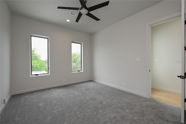 spare room featuring carpet flooring and ceiling fan