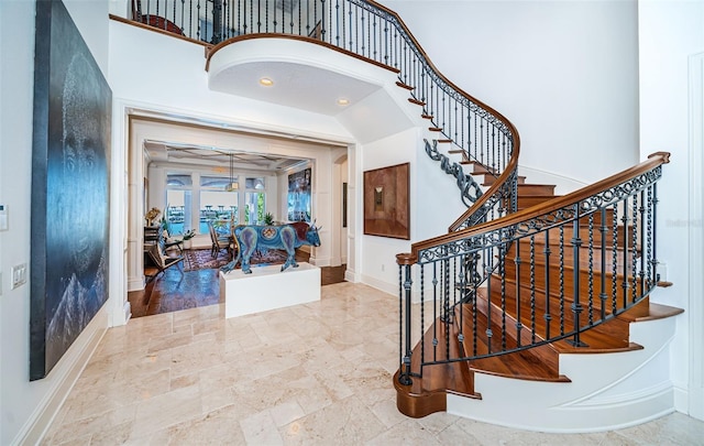 foyer entrance featuring a towering ceiling