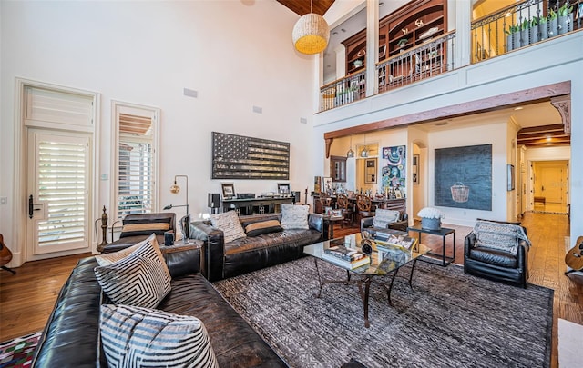 living room featuring hardwood / wood-style flooring and a high ceiling