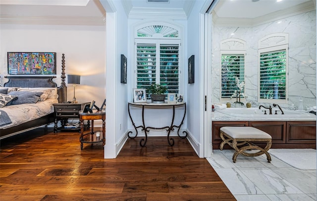 bedroom featuring ornamental molding and dark hardwood / wood-style flooring