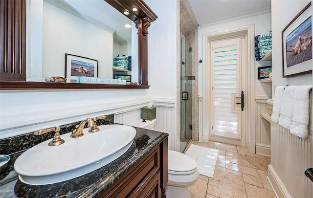 bathroom featuring toilet, walk in shower, crown molding, and vanity