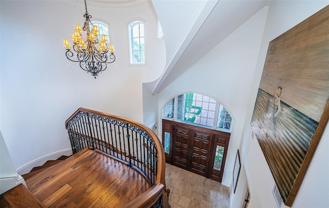 foyer entrance with a high ceiling and a notable chandelier