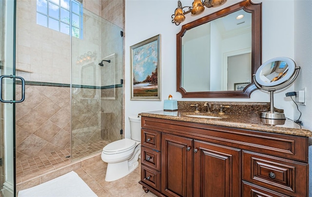 bathroom featuring vanity, toilet, tile patterned floors, and an enclosed shower