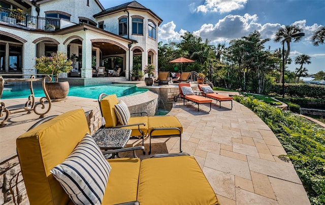 view of pool with a patio area and ceiling fan