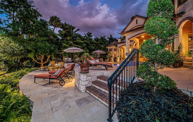 view of patio terrace at dusk