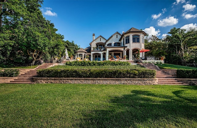 rear view of property featuring a yard