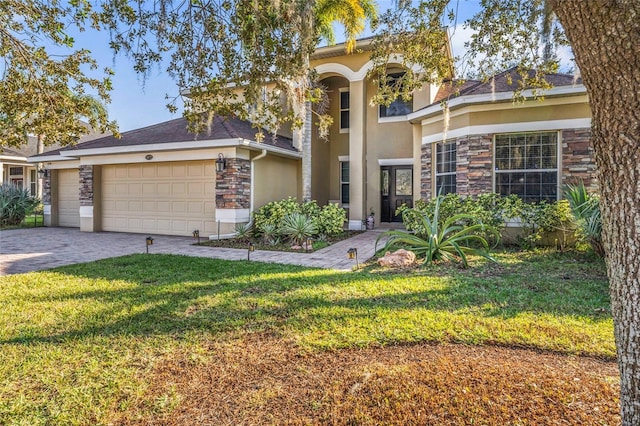 view of front of home with a garage and a front lawn