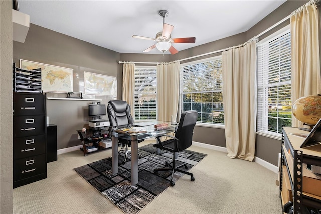 carpeted office with plenty of natural light and ceiling fan