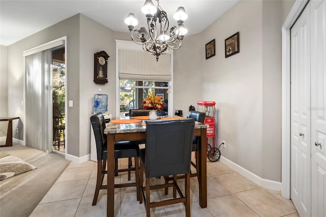 tiled dining area with a chandelier