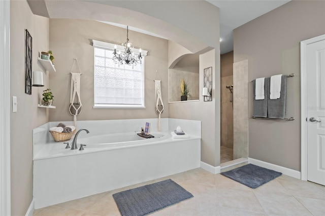 bathroom with tile patterned floors, separate shower and tub, and a notable chandelier