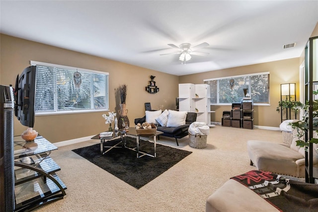 living room with carpet, a wealth of natural light, and ceiling fan