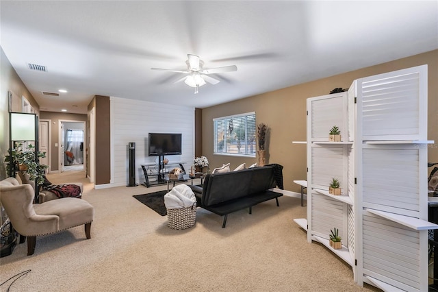 living room with ceiling fan and light colored carpet