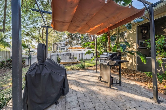 view of patio with a grill and a pergola