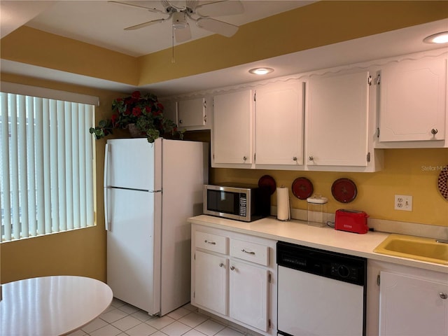 kitchen with ceiling fan, sink, light tile patterned flooring, white appliances, and white cabinets