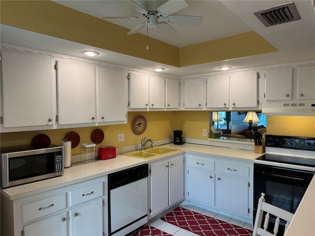 kitchen with sink, white appliances, white cabinetry, and exhaust hood