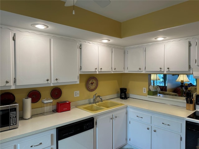 kitchen featuring white dishwasher, white cabinetry, and sink