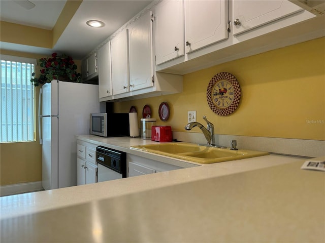 kitchen featuring white cabinetry, white appliances, and sink