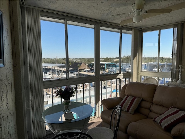 sunroom / solarium with a wealth of natural light and ceiling fan