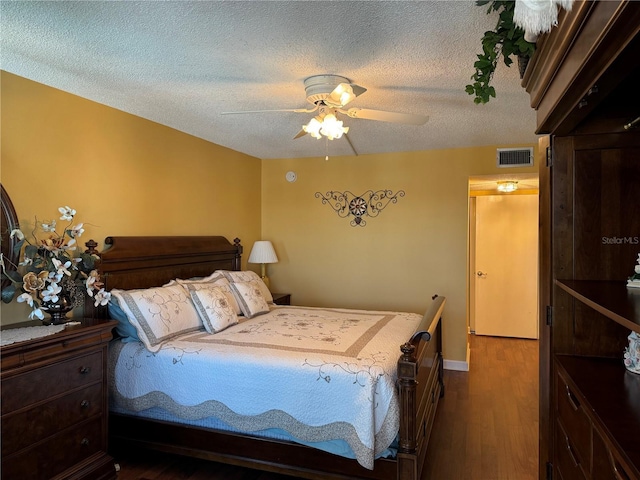 bedroom featuring a textured ceiling, ceiling fan, and dark wood-type flooring