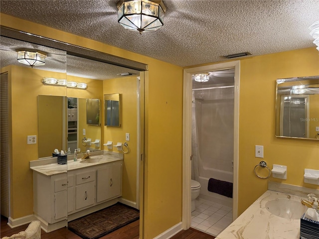 full bathroom with shower / bath combo, a textured ceiling, vanity, hardwood / wood-style flooring, and toilet