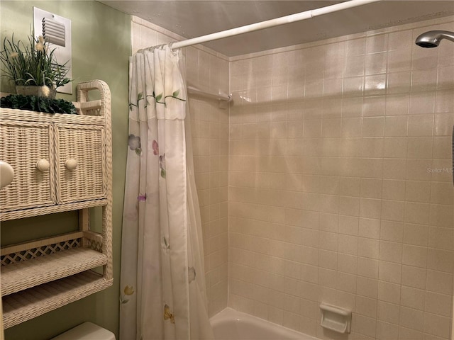 bathroom with toilet and shower / tub combo with curtain