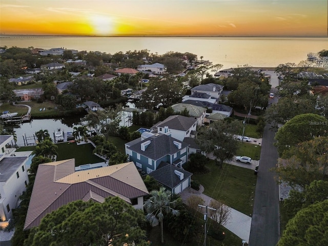 aerial view at dusk with a water view